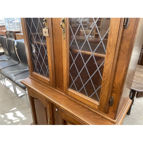 2142 - A MODERN TWO DOOR BOOKCASE ON BASE, WITH GLAZED LEADED UPPER PORTION AND CUPBOARDS BELOW, 40