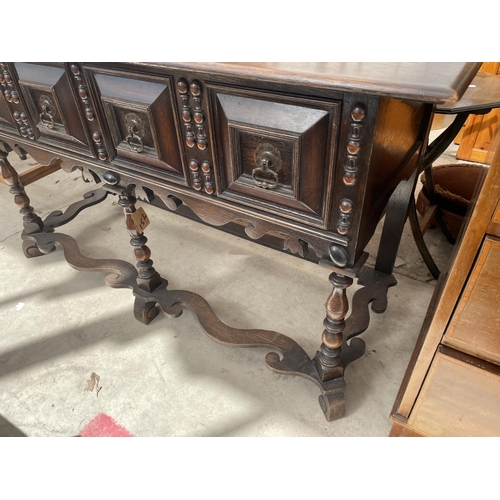 2153 - AN OAK JACOBEAN STYLE DRESSER HAVING TWO DRAWERS WITH RAISED PANELS, FRONT TURNED LEGS ON FLAT STRET... 