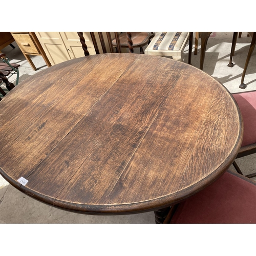 2168 - AN EARLY 20TH CENTURY OVAL OAK WIND-OUT DINING TABLE ON BARLEYTWIST LEGS, 54X41.5