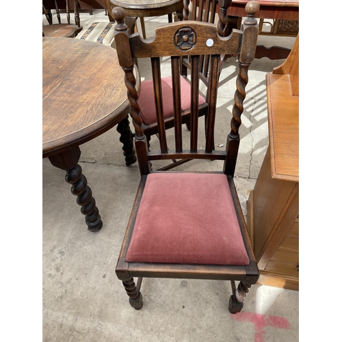 2168 - AN EARLY 20TH CENTURY OVAL OAK WIND-OUT DINING TABLE ON BARLEYTWIST LEGS, 54X41.5