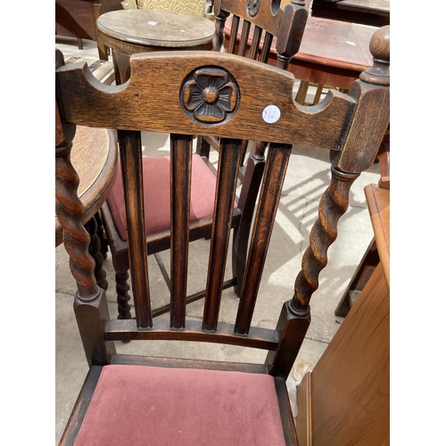 2168 - AN EARLY 20TH CENTURY OVAL OAK WIND-OUT DINING TABLE ON BARLEYTWIST LEGS, 54X41.5