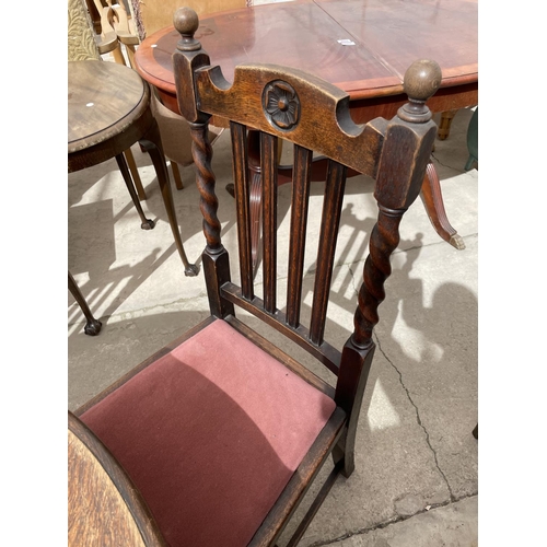 2168 - AN EARLY 20TH CENTURY OVAL OAK WIND-OUT DINING TABLE ON BARLEYTWIST LEGS, 54X41.5