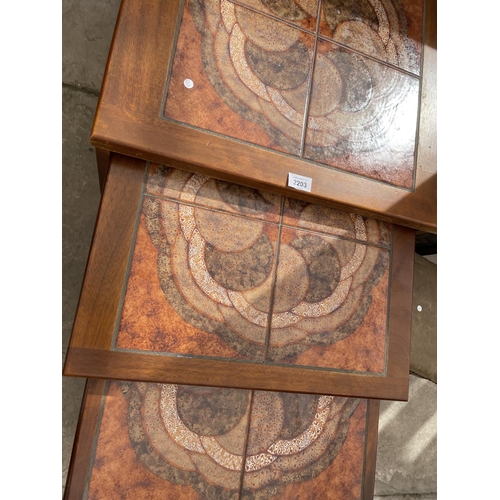 2203 - A RETRO TEAK FRAMED NEST OF THREE TABLES WITH INSET TILED TOP