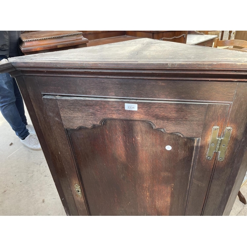 2231 - A GEORGE III OAK CORNER CUBPAORD WITH PANEL DOOR, H-BRASS HINGES AND SHAPED INTERIOR SHELVES