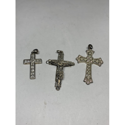 557 - THREE SILVER CROSSES IN A PRESENTATION BOX