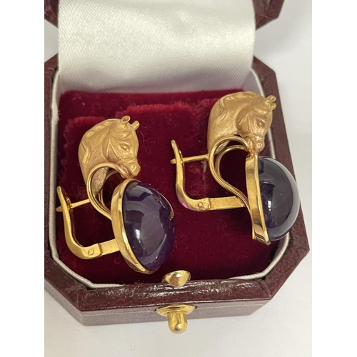 566 - A PAIR OF 12 CARAT YELLOW GOLD HORSES HEAD  DESIGN EARRINGS WITH CABOUCHON AMETHYST  DECORATION BY L... 