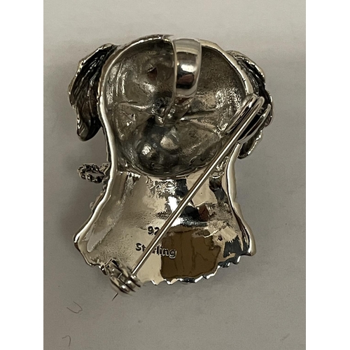 567 - A SILVER BROOCH IN THE DESIGN OF A DOG WITH GLASS EYES