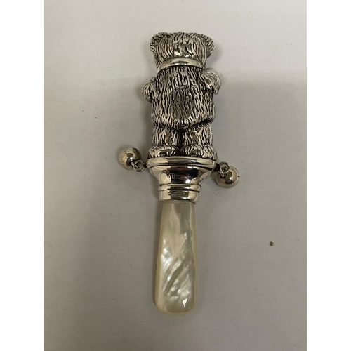 578 - A SILVER MARKED 925 BABIES RATTLE WITH MOTHER OF PEARL HANDLE IN THE DESIGN OF A TEDDY BEAR WITH BEL... 