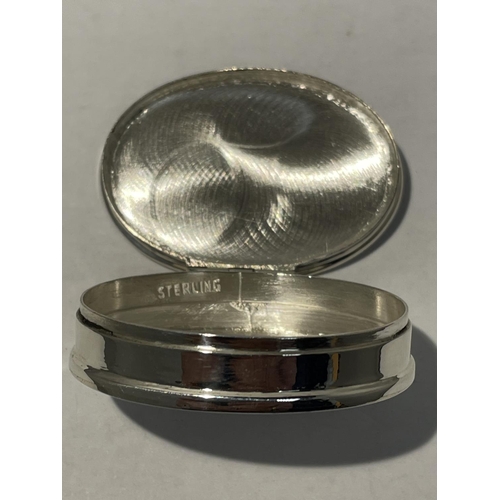 588 - A SILVER PILL BOX WITH AN ENAMEL EROTIC DESIGN ON THE LID