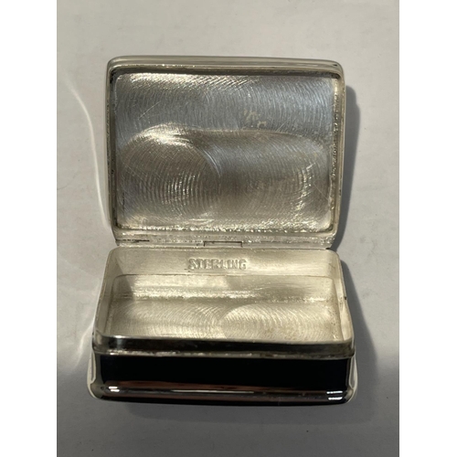 597 - A SILVER PILL BOX WITH AN ENAMEL EROTIC DESIGN ON THE LID