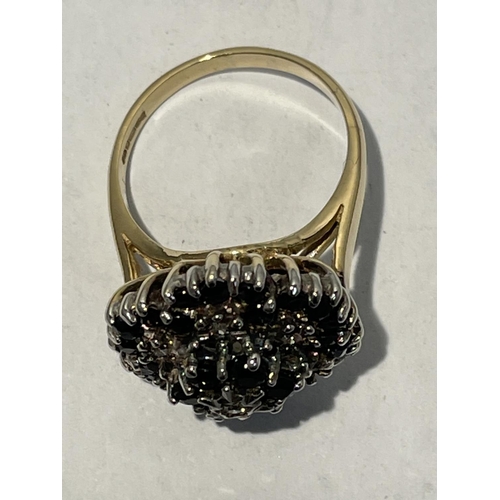 613 - A 9CT GOLD RING WITH THIRTY SAPPHIRES AND SEVEN DIAMONDS. SIZE N/O - 5.7GMS