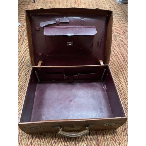 389 - A VINTAGE LEATHER SUITCASE