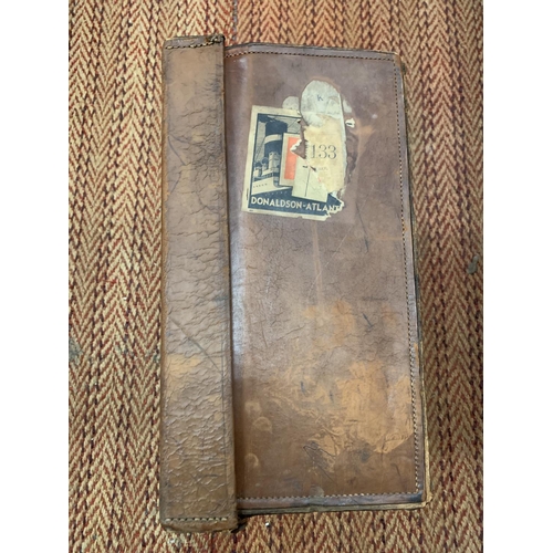 389 - A VINTAGE LEATHER SUITCASE