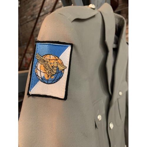 396 - A MILITARY JACKET WITH A PELICAN EMBLEM ON THE ARM