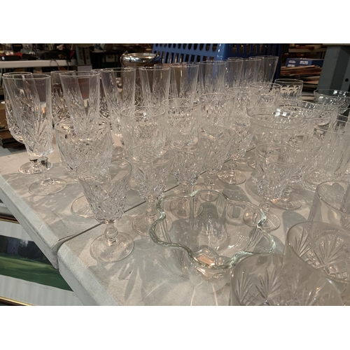 399 - A LARGE QUANTITY OF CUT GLASS TO INCLUDE SHERRY AND PORT GLASSES AND CHAMPAGNE FLUTES