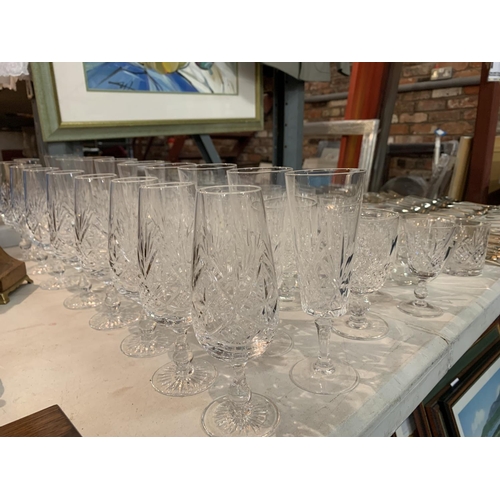 399 - A LARGE QUANTITY OF CUT GLASS TO INCLUDE SHERRY AND PORT GLASSES AND CHAMPAGNE FLUTES