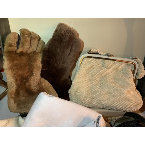 423 - A VINTAGE SUITCASE CONTAINING LINEN, FUR MITTENS AND TWO VINTAGE HAND BAGS, ONE MADE IN BRITISH HONG... 