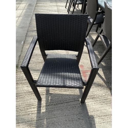 1687 - A RATTAN GARDEN SET WITH GLASS TOPPED TABLE AND 5 ARM CHAIRS