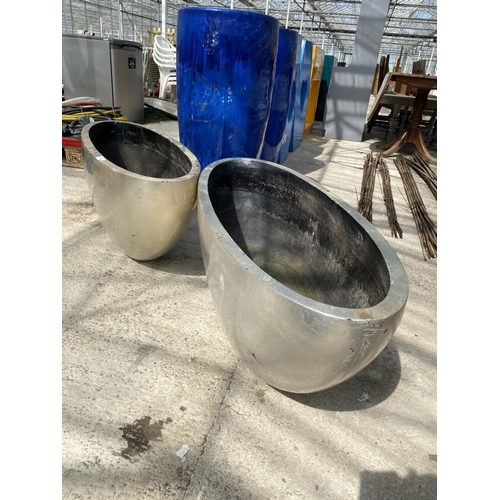 1746 - A PAIR OF DECORATIVE SILVER HALF MOON FIBRE GLASS PLANTERS (H:41CM W:100CM)