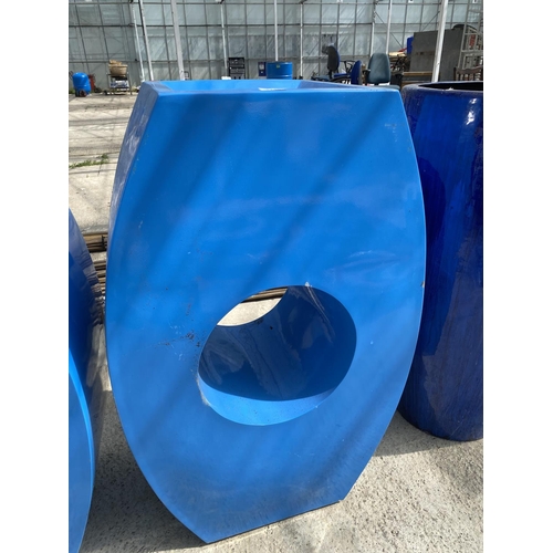 1748 - A PAIR OF DECORATIVE RETRO BLUE FIBRE GLASS PLANTERS ONE WITH A CIRCLE AND ONE WITH A HEART (H:90CM)