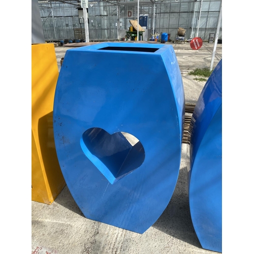 1748 - A PAIR OF DECORATIVE RETRO BLUE FIBRE GLASS PLANTERS ONE WITH A CIRCLE AND ONE WITH A HEART (H:90CM)