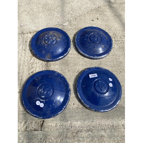 1754 - A GROUP OF FOUR CAR HUB CAPS BELIEVED TO BE FROM A MORRIS MINOR