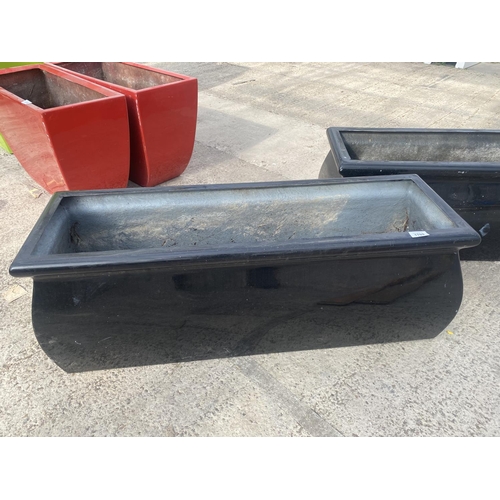 1769 - A PAIR OF LOW BLACK FIBRE GLASS GARDEN PLANTERS (H:36CM W:98CM)