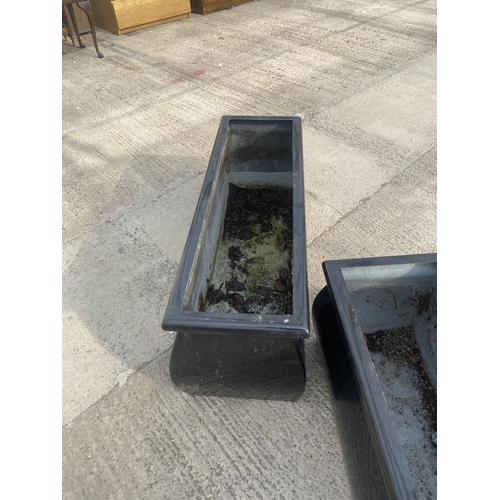 1769 - A PAIR OF LOW BLACK FIBRE GLASS GARDEN PLANTERS (H:36CM W:98CM)