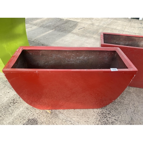 1770 - A PAIR OF LOW RED FIBRE GLASS PLANTERS (H:45CM W:75CM)