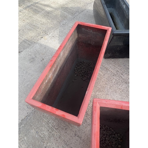 1770 - A PAIR OF LOW RED FIBRE GLASS PLANTERS (H:45CM W:75CM)