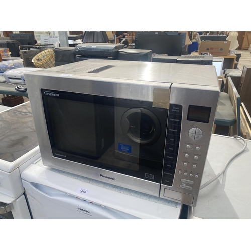 1888 - A SILVER PANASONIC MICROWAVE BELIEVED IN WORKING ORDER BUT NO WARRANTY