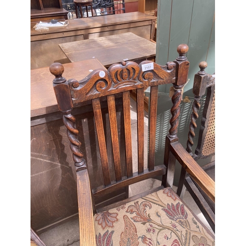 2157 - AN EARLY 20TH CENTURY OAK ELBOW CHAIR ON BARLEY TWIST SUPPORTS AND SIMILAR DINING CHAIR