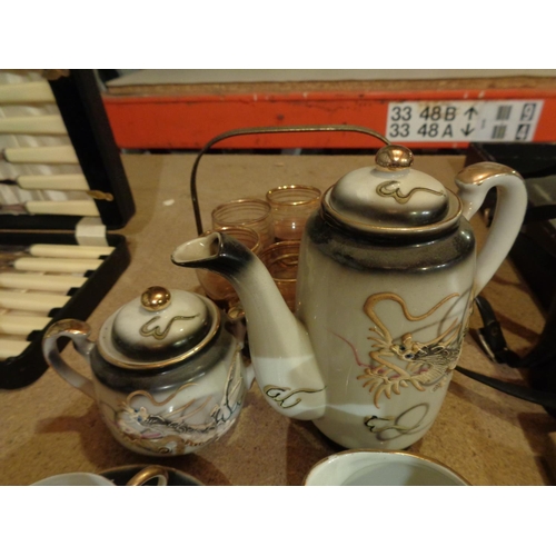 818 - AN ORIENTAL TEA SET WITH DRAGON DESIGN AND A METAL CRUET SET