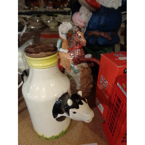 845 - A LARGE GARDEN GNOME, TWO JULIANA MONEY BOXES, A JUG IN THE FORM OF A COW AND A STORAGE JAR IN THE F... 