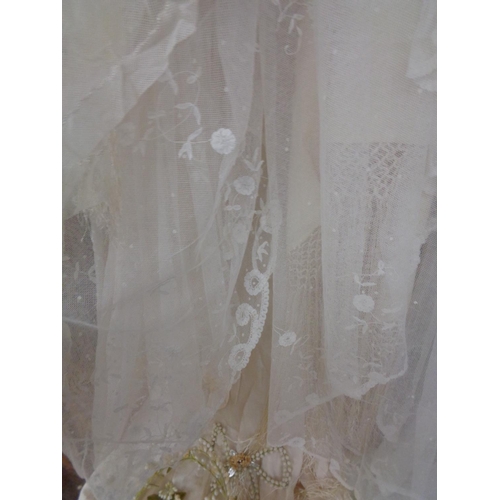 875 - A VINTAGE SATIN WEDDING GOWN, A SILK FRINGED WEDDING SHAWL, TWO LACE VEILS, A VINTAGE BEADED BAG AND... 