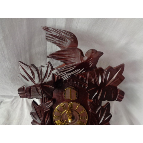 876 - A BATTERY OPERATED WOODEN CUCKOO CLOCK