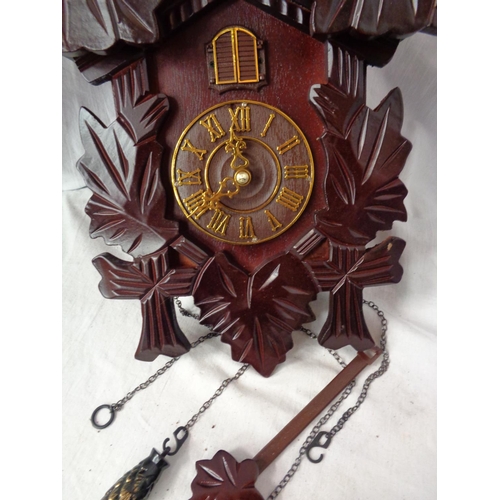 876 - A BATTERY OPERATED WOODEN CUCKOO CLOCK