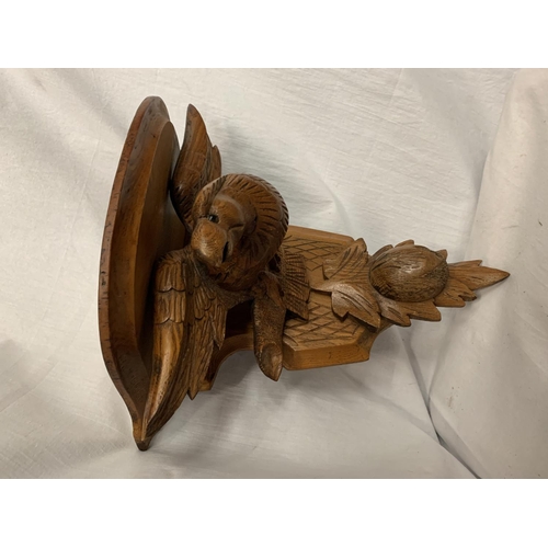 23 - A CARVED WOODEN WALL SCONCE DEPICTING AN EAGLE AND A THISTLE 30.5CM X 35CM