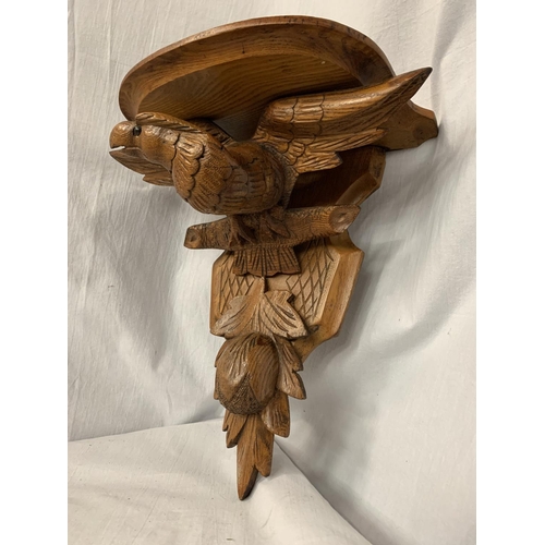 23 - A CARVED WOODEN WALL SCONCE DEPICTING AN EAGLE AND A THISTLE 30.5CM X 35CM