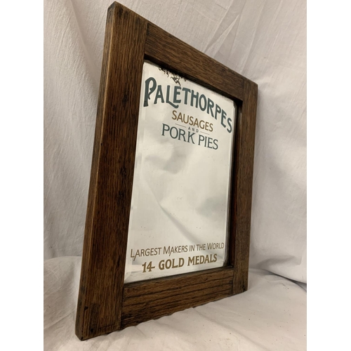 26 - A WOODEN FRAMED ARTS AND CRAFTS STYLE ADVERTISING MIRROR FOR 'PALETHORPES SAUSAGES AND PORK PIES'