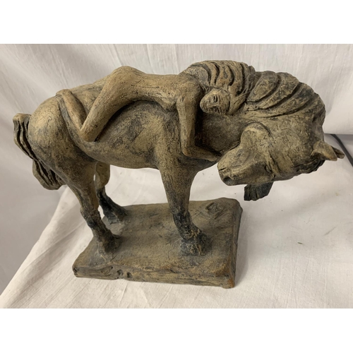 27 - A CARVED STONE ORNAMENT IN THE FORM OF A HORSE AND NUDE FEMALE RIDER H: 23CM