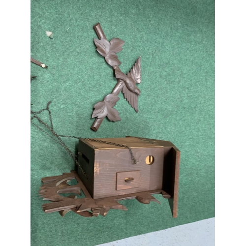 60 - A DECORATIVE WOODEN CUCKOO CLOCK WITH WEIGHTS