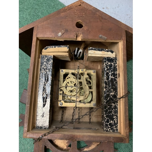 60 - A DECORATIVE WOODEN CUCKOO CLOCK WITH WEIGHTS