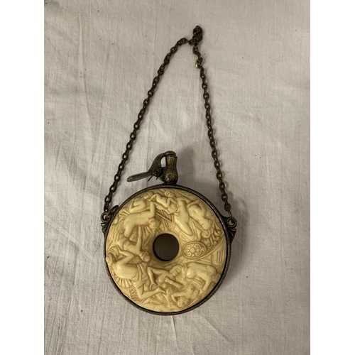 9 - A HEAVILY CARVED GUNPOWDER FLASK WITH WHITE METAL DETAIL AND CHAIN ATTACHED DIA: 10.5CM