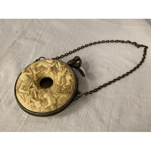 9 - A HEAVILY CARVED GUNPOWDER FLASK WITH WHITE METAL DETAIL AND CHAIN ATTACHED DIA: 10.5CM