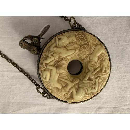 9 - A HEAVILY CARVED GUNPOWDER FLASK WITH WHITE METAL DETAIL AND CHAIN ATTACHED DIA: 10.5CM