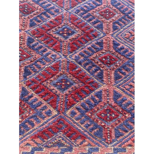 1987 - A BLUE AND RED PATTERN RUG