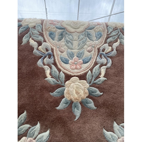 1990 - AN OVAL BROWN PATTERN RUG