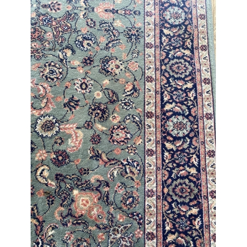 1994 - A LARGE GREEN PATTERNED RUG