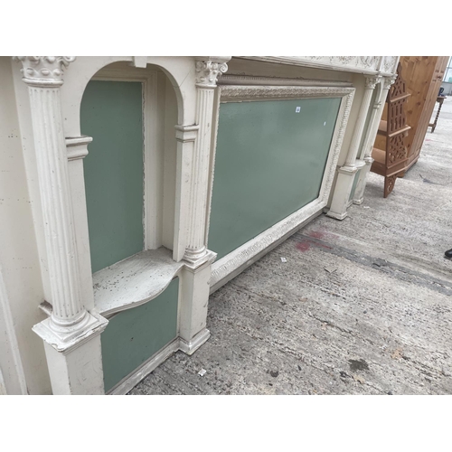 2535 - A LARGE WHITE PAINTED VICTORIAN FIREPLACE OVERMANTLE WITH SMALL CORINTHIAN STYLE COLUMN AND FOLIATE ... 